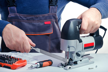 Professional technician working in repair service. Repairing electrical tools.