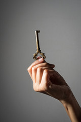 Old key in girl hand.