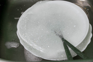 Washing kitchen ware on the sink