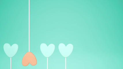 Minimal love and care concept idea, orange and turquoise heart shape candies on pastel background with copy space