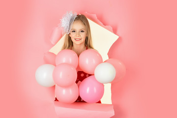 beautiful little girl with balloons on pink background