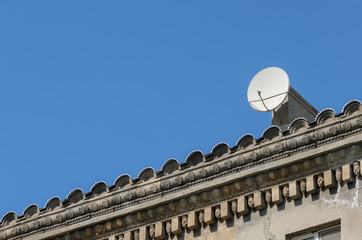 Satellite dish on the roof of an old building