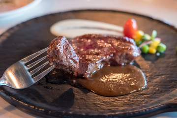 Medium rare meat on plate with sauce