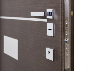 Open armored door. Door lock, Dark brown door closeup. Modern interior design, door handle. New...