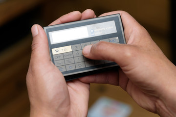 Woman using a retro old PDA / Calculator