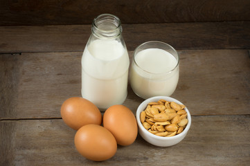 Nut in cup with milk bottle and eggs.