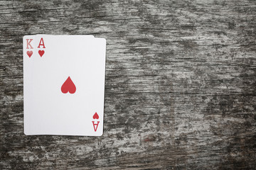ace and king playing cards on a wooden table with copyspace