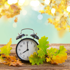 Naklejka na ściany i meble Autumn time - fall leaves with clock