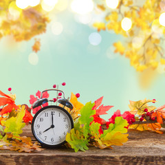 Autumn time - fall leaves with clock