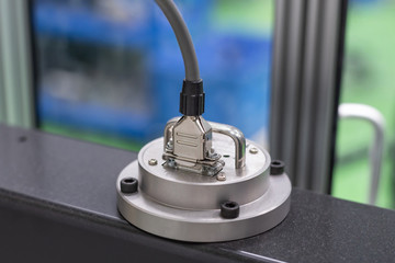 Close up of 15 pin connector cable plugged to load cell of universal machine