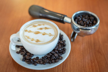 Hot coffee with art pattern in white cup