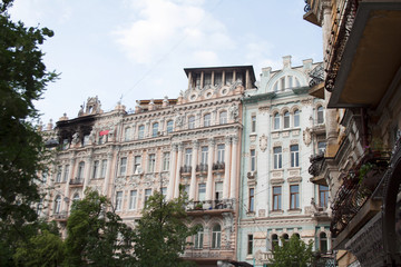 Old architecture buildings facades with stucco, sculptures and balconies