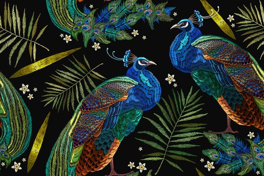 Embroidery peacocks tropical birds and palm leaves seamless pattern. Fashionable template for design of clothes. Classical fashionable embroidery beautiful peacocks