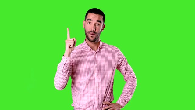 Confident young man pointing up - Chroma background