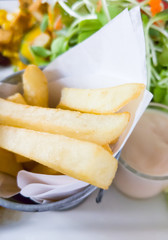 Large french fries in the metal bucket.