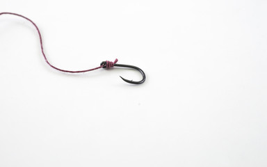 Fishing hook with a red rope on a white background.