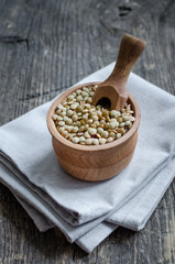 Brown dried lentils in a wooden bowl