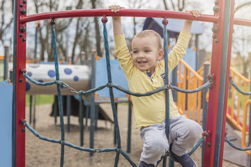 Obraz premium Adorable little boy with blue eyes having fun outdoor