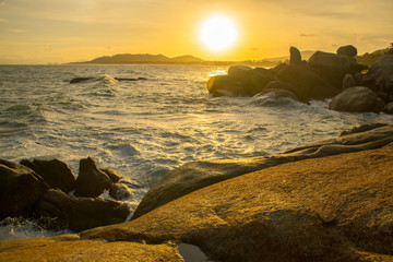 The Rock Hin Ta and Hin Yai from Thailand Island of Koh Samui. The picturesque pile of rocks on the beach, illuminated by the sunset.