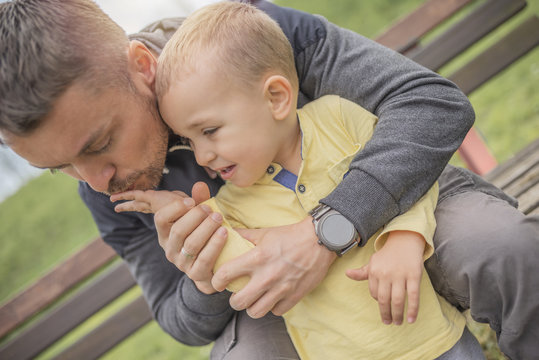 Closeup Portrait Of Father And Crying Child In Park