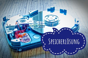 Hard drive 3.5 inches as a data storage with motherboard on a bamboo table and in german Speicherlösung in english storage solution