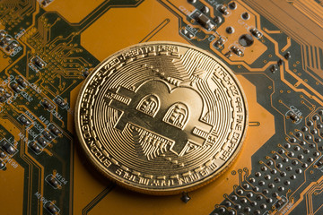 Gold coin bitcoin on the motherboard