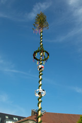 Decorated maypole in bavaria in germany in front of blue sky