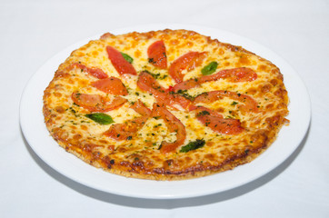 Pizza with melted cheese and tomato slices