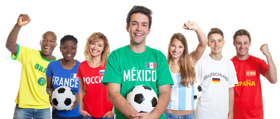 Laughing mexican soccer supporter with ball and fans from other countries