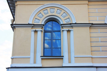 Window Archway Frame on Ornamental Facade Wall of Classical Building. Architecture Detail of Historic Decorative House Exterior of Minimalistic Windows with Small Pillars against Sky Background.