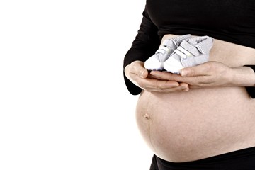pregnant woman with both hands on her belly