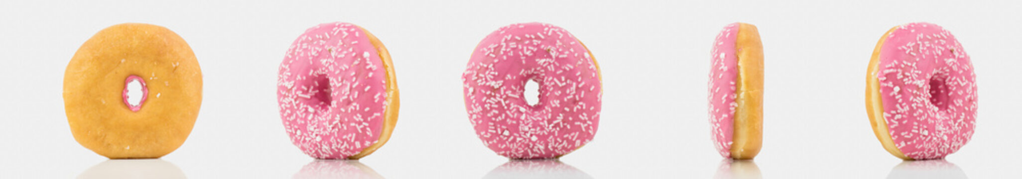 Bunch Of Delicious Pink Colored Donut On White Background With White Chocolate On It.Isolated