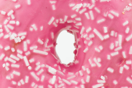 Closeup Of Delicious Pink Colored Donut On White Background With White Chocolate On It.Isolated