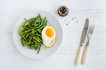 Cooked green beans with fried egg