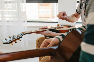 Learning to play the guitar. Music education.
