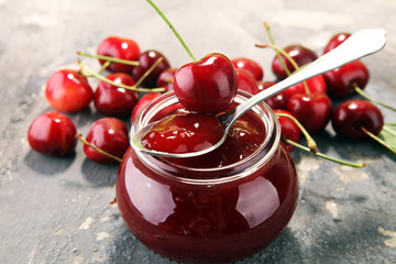 Rustic jar with cherry jam and fresh cherries, homemade preserves