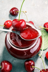 Rustic jar with cherry jam and fresh cherries, homemade preserves