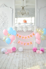 Birthday party decorations. A lot of balloons blue and pink colors. Cake for holiday party. 