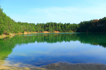 Forest lake with emerald water. Beautiful lake panorama