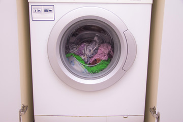 Front view of a washing machine drum during cleaning clothes