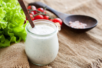 Cream and herbs dressing in glass jar - 206620509