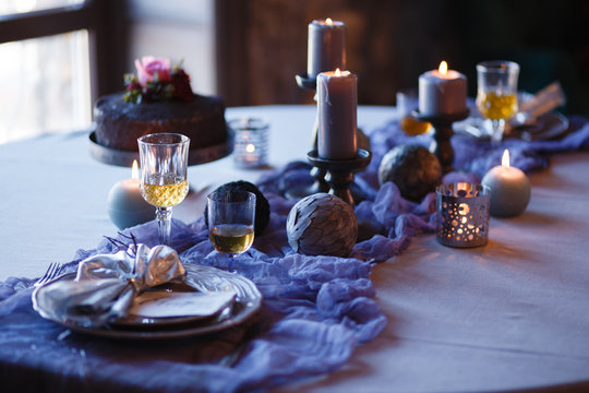 Luxurious dinner in dark style. Gray decoration served table.