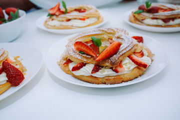 Cakes Paris Brest with strawberries, mint on white table