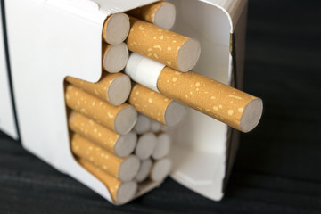 a pack of cigarettes on a table made of ebony, macro