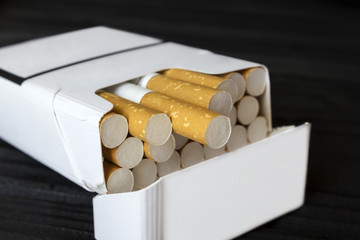a pack of cigarettes on a table made of ebony  close-up