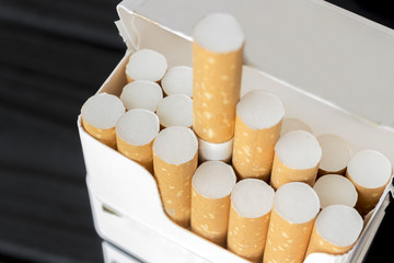 a pack of cigarettes is on a table made of ebony