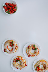 Cakes Paris Brest with strawberries, mint on white table