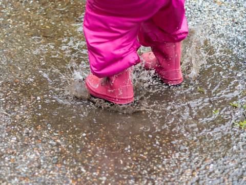 child jumping in a buddle