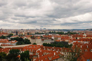 Fototapeta na wymiar Czech Republic, Prague, July 25, 2017: Panoramic view of the city. Red Roofs of houses and structures of the old city in the summer in cloudy cloudy weather