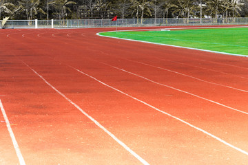 Red running track, white line in the stadium